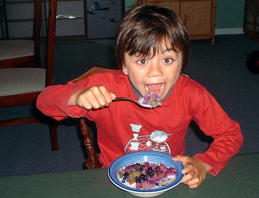 Chld enjoying a healthy dessert